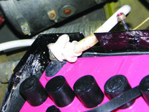 Battery Cable without protective grommet can cause a short circuit and electrical failure.